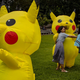 Children hug characters dressed as Pikachu